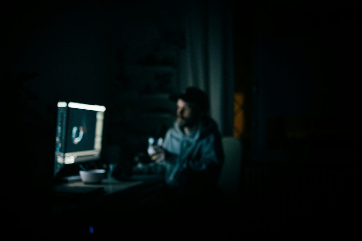 A man working at his computer late at night